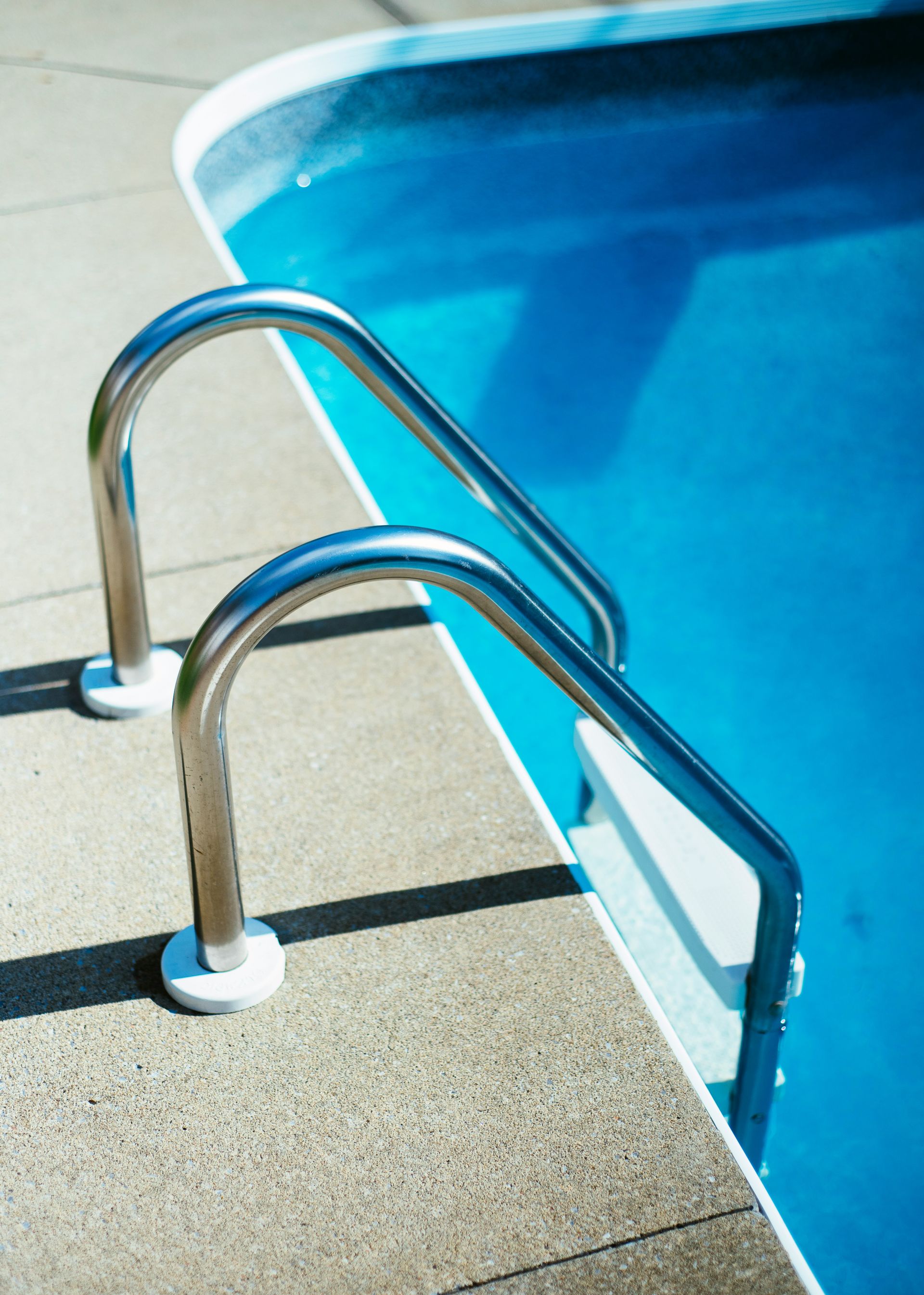 grey and white pool ladder
